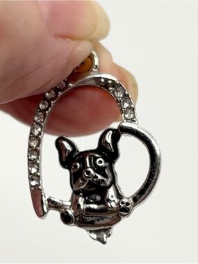 A Silver Pendant featuring a little bull dog of sorts